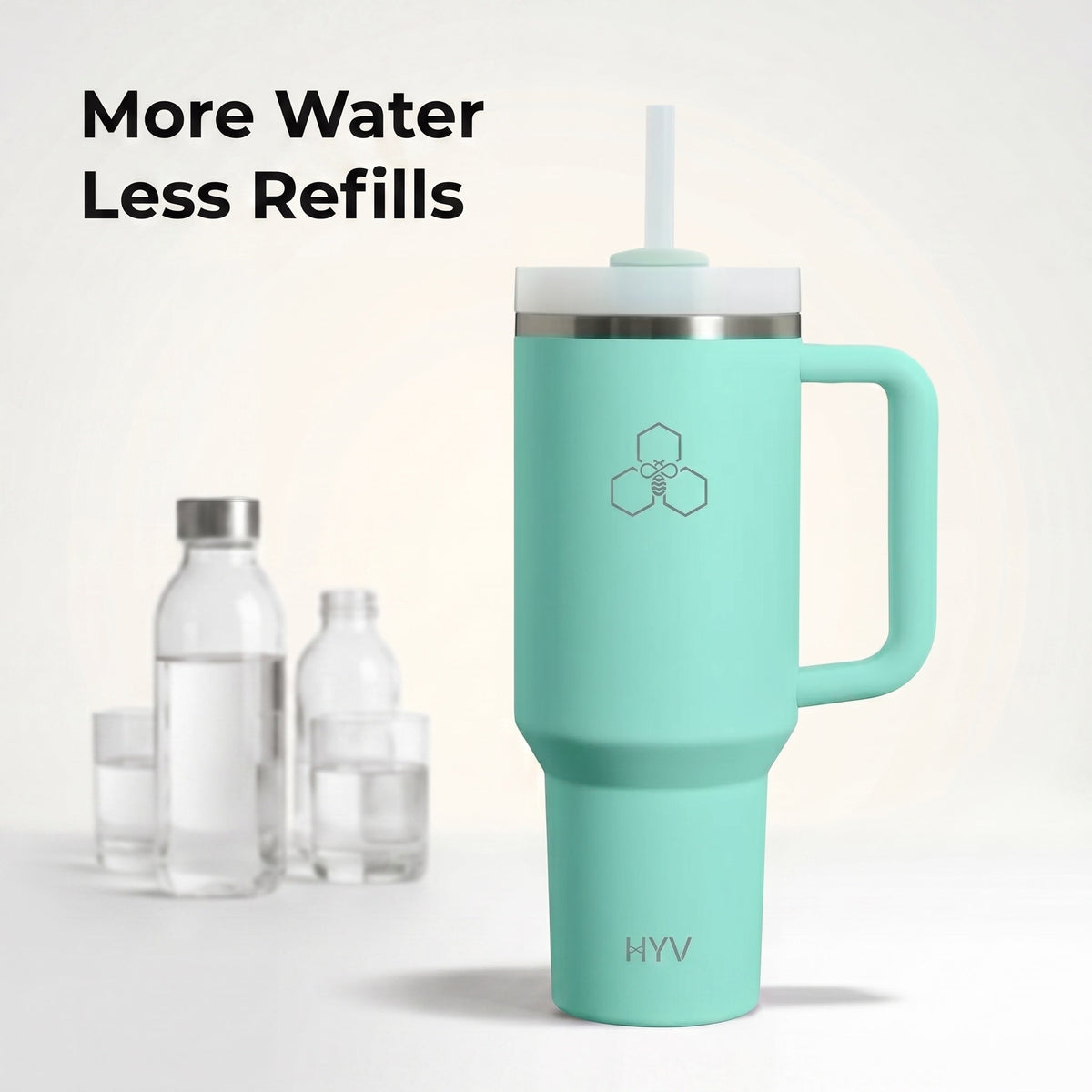 Mint HYV HydroFlow tumbler beside three small disposable water bottles for scale