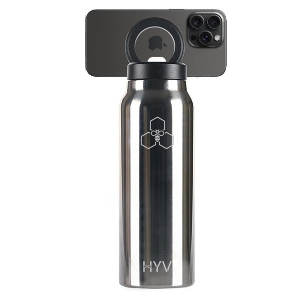 HYV SnapSip 750ml bottle in brushed steel with a phone on its magnetic lid