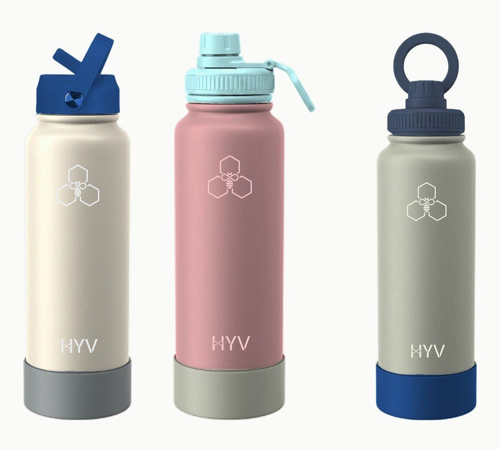 Three HYV bottles in cream, rose and sage with different lids and silicone boots